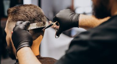 Client doing hair cut at a barber shop salon